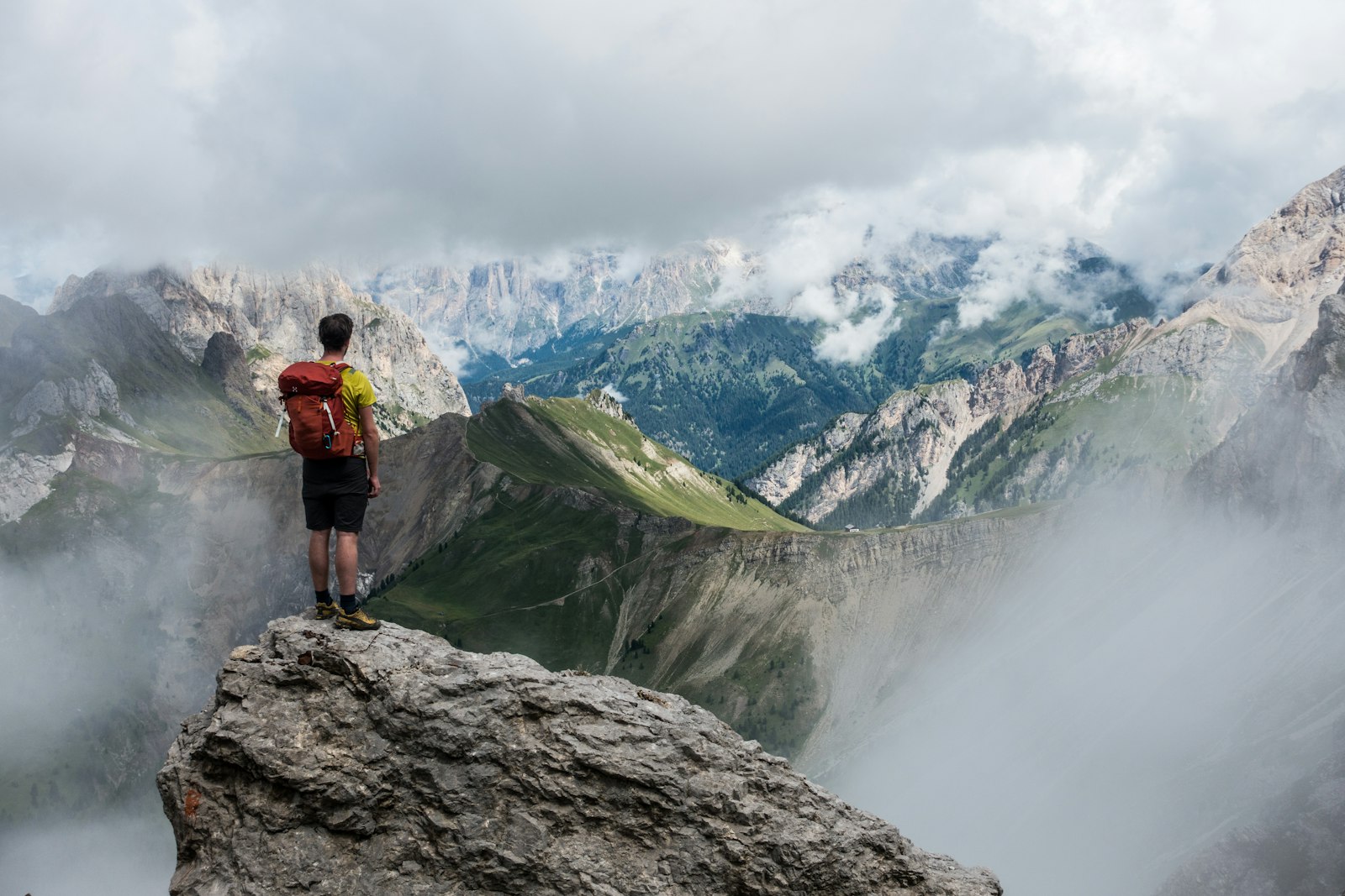 Climber on a rock face with open sky